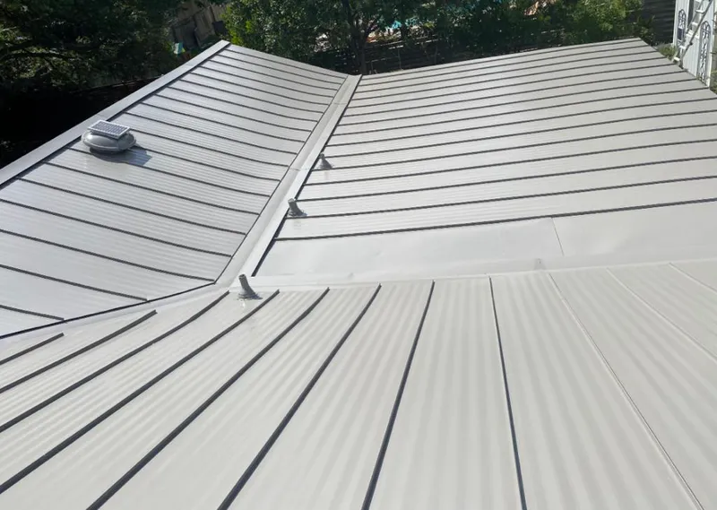 Solar attic fan installed on a metal roof for Roof Ventilation in Bainbridge Island